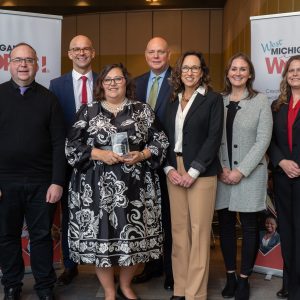 Winners of the West Michigan Works! 2024 Partner of the Year Award gather with staff .